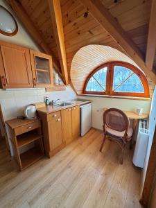 a kitchen with a table and a chair in a room at Vila Banga in Nida +14 photos