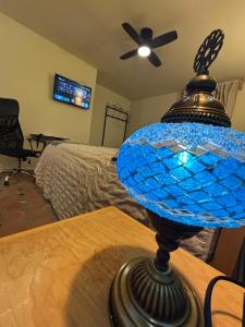 a blue glass lamp sitting on top of a table at La Estancia del Rey David in San Luis Potosí