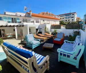 a group of chairs and tables on a patio at Native Surfhouse in Praia da Areia Branca
