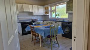 a kitchen with a table with a blue table cloth at The Yoke B&B and Self-Catering Accommodation Laois in Ballybrittas