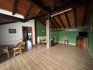 an empty room with green walls and wooden floors at CASA RURAL ETXANO in Amorebieta-Etxano