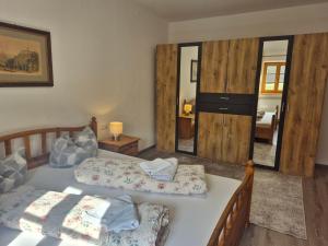 a bedroom with two beds and a mirror at Gasthaus Staufenbrücke in Bad Reichenhall