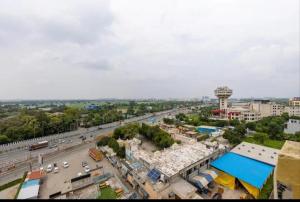 an overhead view of a city with a road and a tower at Hotel Lotus Paradise in Sonīpat