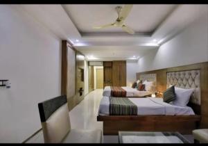 a hotel room with two beds and a ceiling fan at Hotel Lotus Paradise in Sonīpat
