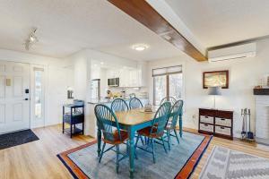 a kitchen and dining room with a table and chairs at Saltbox 12F in White River Junction