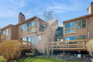 a large house with wooden balconies on it at Saltbox 12F in White River Junction