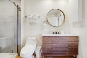 a bathroom with a toilet and a mirror at Saltbox 12F in White River Junction +27 photos