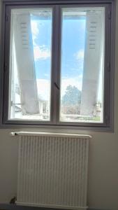 a window in a room with a radiator in front of it at Chambre Deluxe avec Salle de bain et clim in Bourges