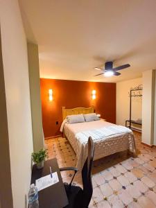 a bedroom with a bed and a ceiling fan at La Estancia del Rey David in San Luis Potosí