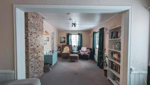 a living room with a brick wall at Traditional Arctic Farmhouse in Sørlenangen