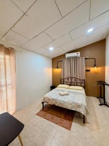 a bedroom with a bed with a metal headboard at NorvillaA Pantai Cenang in Pantai Cenang