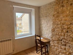 a dining room with a table and a window at Au point du jour Ch1 in Récourt-le-Creux