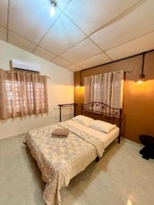 a bedroom with a large bed in a room at NorvillaA Pantai Cenang in Pantai Cenang +10 photos