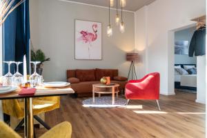 a living room with a couch and a table at Boutique Apartment 74 in Krefeld