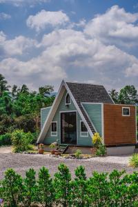 a small house with a wooden door at Hun Resort in Khanom