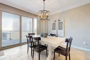 a dining room with a table and chairs and a large window at TOPS'L Tides in Destin