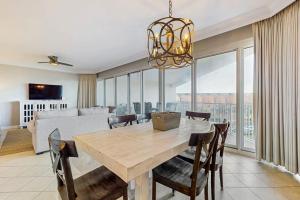a dining room with a table and chairs and a living room at TOPS'L Tides in Destin