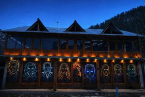 a building with a bunch of faces painted on it at The North Rememberzz in Kalgha +12 photos