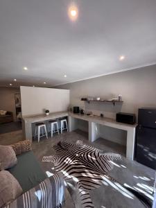 a living room with a zebra rug on the floor at LuVic Guesthouse in Naboomspruit