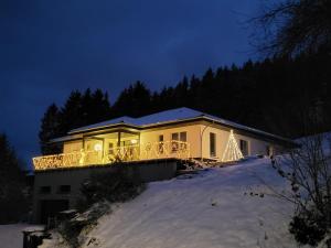 a house with a christmas tree on the porch at Ferienwohnung Zum Adlernest in Hellenthal