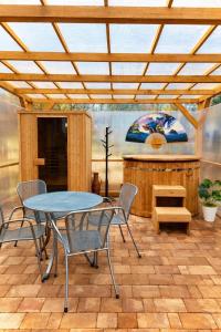 a patio with a table and chairs and a counter at Ádám nyaralóház in Balatonalmádi