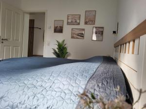 a bedroom with a bed with a blue comforter at Ferienwohnung Zum Adlernest in Hellenthal