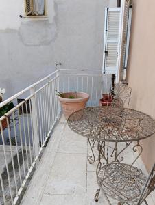 a balcony with two tables and chairs on a balcony at Dimora Victoria in Ascoli Piceno