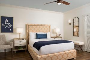 a bedroom with a large bed and a chair at Indigo Inn in Charleston