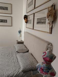 a bedroom with a bed and a mirror on the wall at Dimora Victoria in Ascoli Piceno