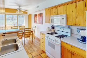 a kitchen with a white stove and a sink at Castillo De Las Rocas 3418 in Moab