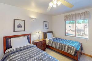 a bedroom with two beds and a window at Castillo De Las Rocas 3418 in Moab +16 photos