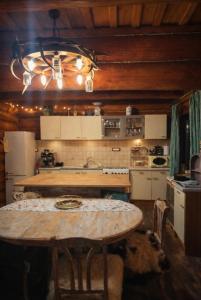 a kitchen with a table in the middle of it at Blueberry Blockhouse in Hărniceşti +14 photos