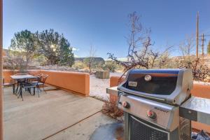 a grill on a patio with a table and chairs at Castillo De Las Rocas 3418 in Moab