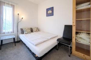 a bedroom with a bed and a desk and a chair at Ádám nyaralóház in Balatonalmádi