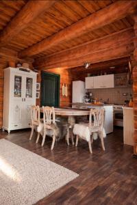 a kitchen with a table and chairs in a room at Blueberry Blockhouse in Hărniceşti