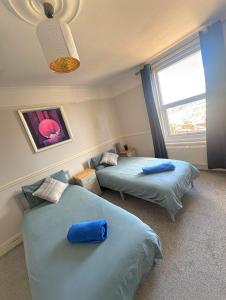 a bedroom with two beds and a window at Lennox Lodge 2 in Portsmouth