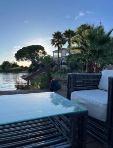 a bed and a table next to a body of water at Sunset Lagoon House in Lagoa