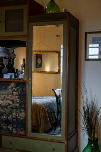 a mirror in a room with a bed in it at Casal di Peppe B&B in Lorenzana