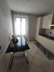 a kitchen with a table and chairs and a window at Casa Mare Relax e Cortesia in Ardea +10 photos