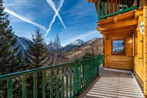 a balcony of a cabin with a view of the mountains at Haus Karin in Heiligenblut