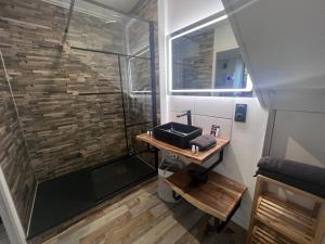a bathroom with a shower and a wooden table at LoveRoom avec SPA privatif Plélo in Plélo +28 photos