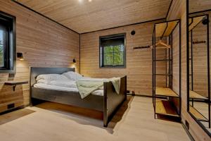 a bedroom with a bed in a wooden wall at Stryn Mountain Lodge in Stryn