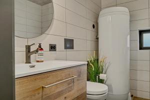 a bathroom with a sink and a toilet at Stryn Mountain Lodge in Stryn +49 photos