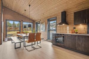 a kitchen and dining room with a table and chairs at Stryn Mountain Lodge in Stryn