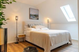 a bedroom with a bed and a skylight at Boutique Apartment 74 in Krefeld