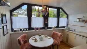 a kitchen with a table and two chairs and windows at Fewo Lieblingsblick, gemütlich & chic in Bad Münstereifel +19 photos