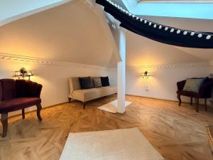 a living room with a couch and two chairs at Chateau D'Amour Luxury Boutique in Bucharest