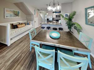 a kitchen with a table and chairs and a crib at Trestles in Padre Island