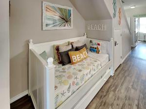 a white crib in a baby room with a crib at Trestles in Padre Island