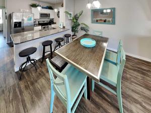 a kitchen with a table and chairs and a counter at Trestles in Padre Island +24 photos